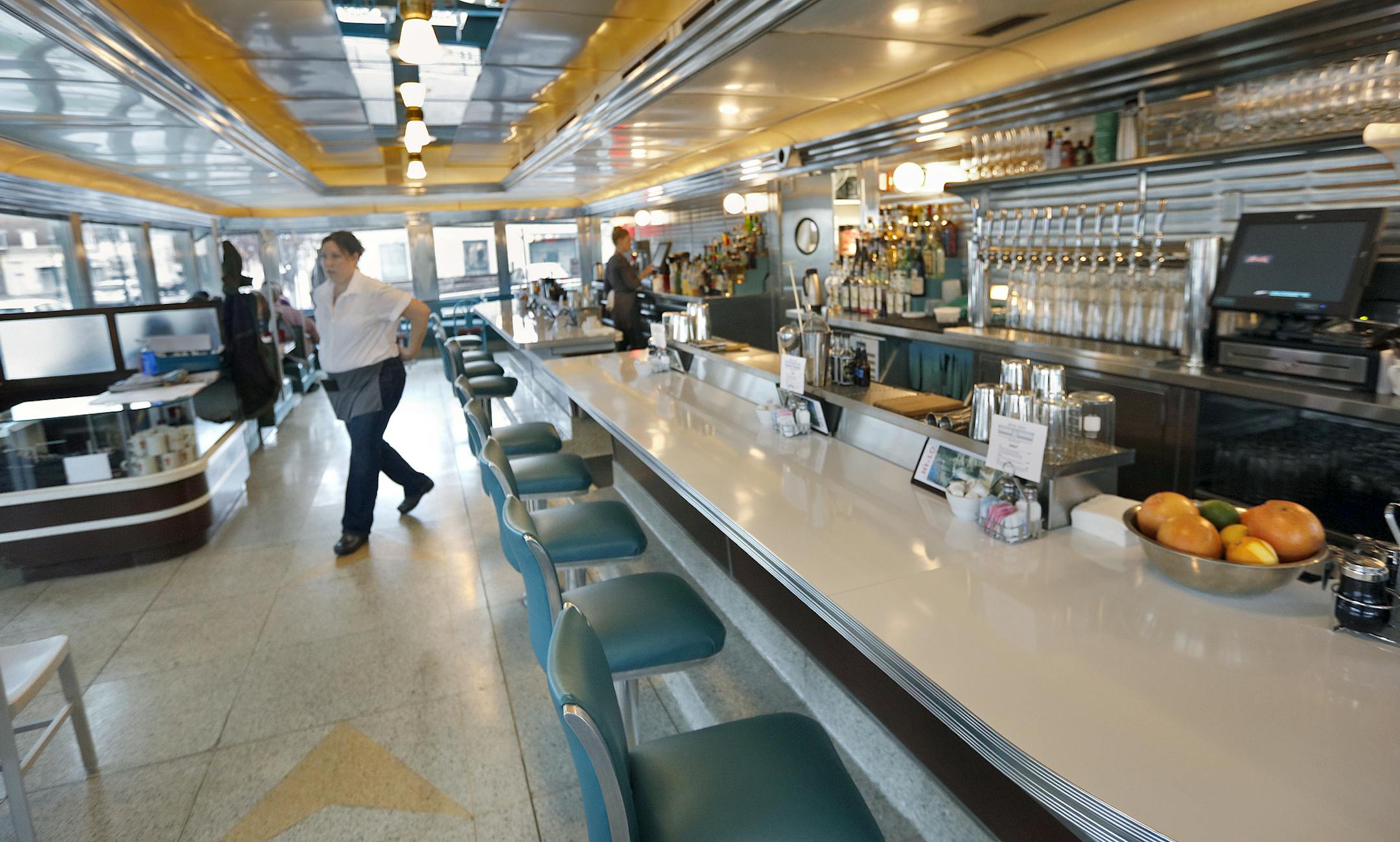 Server Angie Merlin, above, sets a fast pace for the breakfast clients.