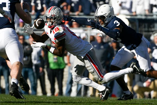 Ohio State wide receiver Marvin Harrison Jr. (18) made a catch against Penn State cornerback Johnny Dixon in last season’s 44-31 Buckeyes victory.