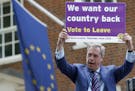 WITH STORY BRITAIN EU FUTURE - In this May 20, 2016 file photo, British politician and leader of the UKIP party Nigel Farage holds up a placard as he 