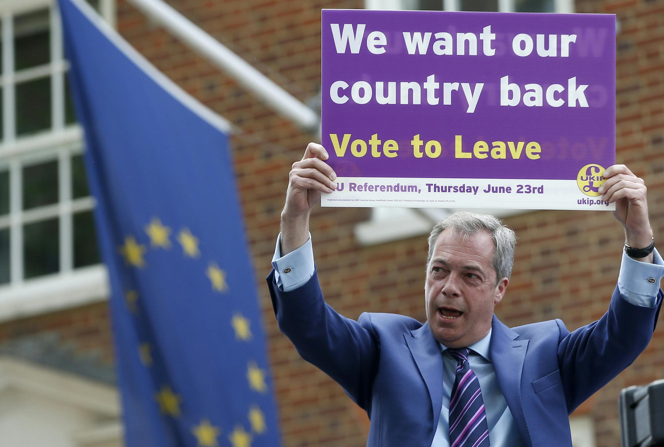 WITH STORY BRITAIN EU FUTURE - In this May 20, 2016 file photo, British politician and leader of the UKIP party Nigel Farage holds up a placard as he launches his party's campaign for Britain to leave the EU, outside the EU representative office in London. Working on how Britain might extricate itself from the EU and whether Europe would unravel in its absence is about as easy as predicting how Britons will vote on June 23, 2016. (AP Photo/Alastair Grant, File)