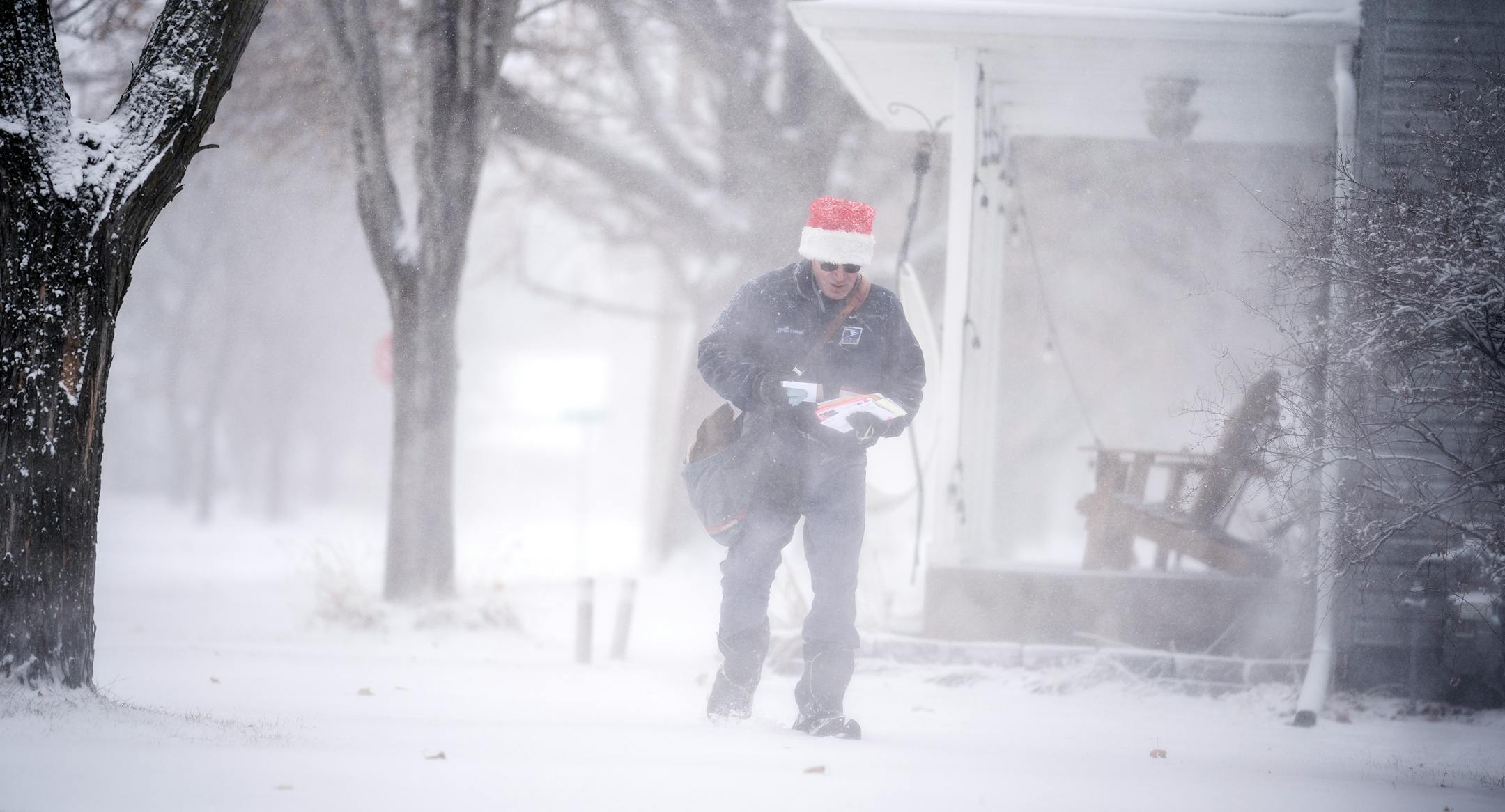 Osseo mail carrier Dennis Niles braved the blowing snow as blizzard like conditions hit Osseo and the Twins Cites on Wednesday, 5-9 inches of snow as expected.