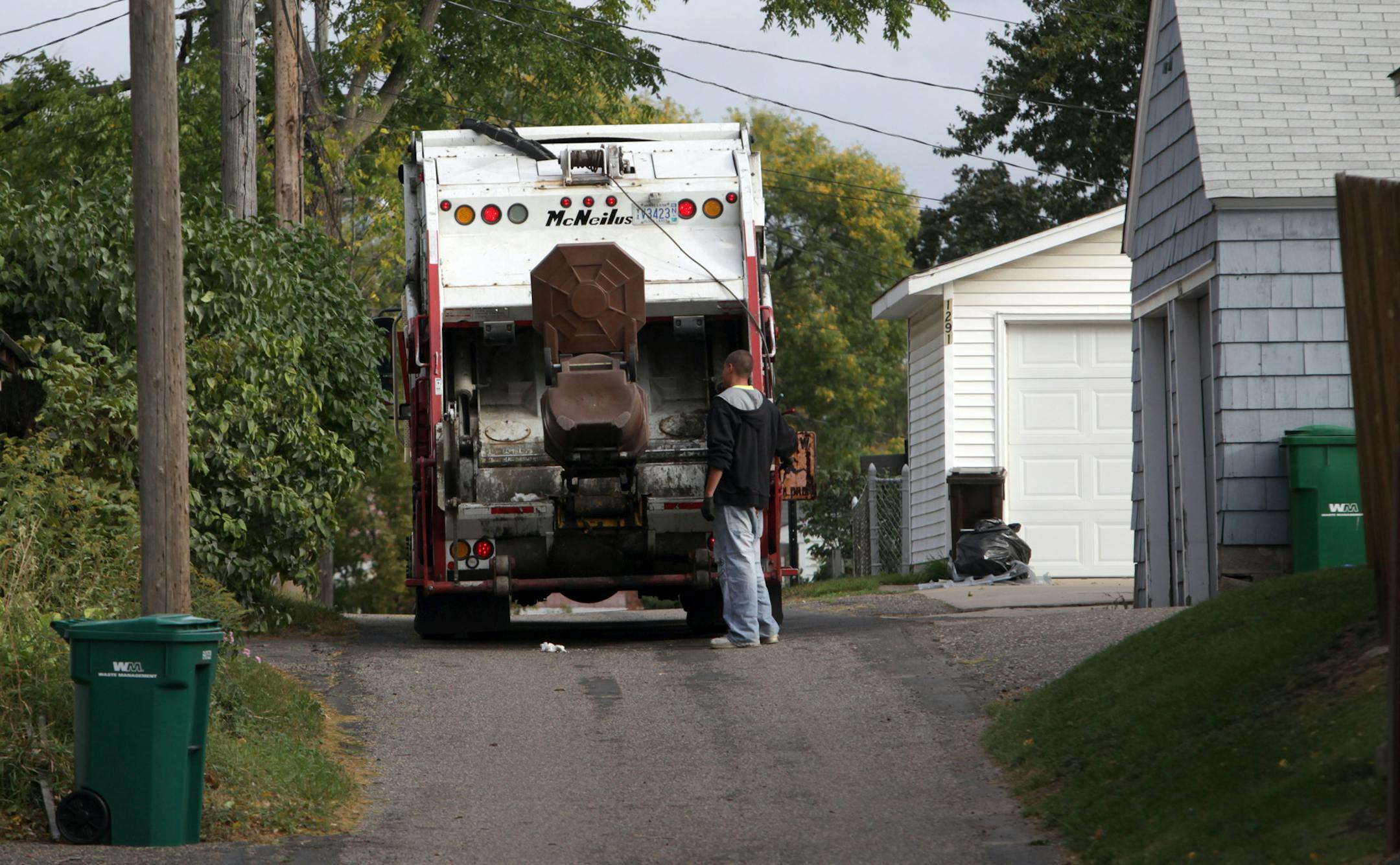 KYNDELL HARKNESS • kharkness@startribune.com 9/29/09St. Paul has a lot of garbage companies[With Waste Management cans on either side, Gene's Disposal Service worker emptied out one of the trash cans near Wheelock and Grotto in St. Paul. The city has more thn a dozen different companies the provide garbage service.