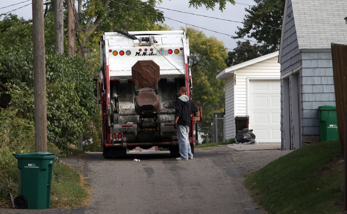 KYNDELL HARKNESS &#x2022; kharkness@startribune.com 9/29/09St. Paul has a lot of garbage companies[With Waste Management cans on either side, Gene's Disposal Service worker emptied out one of the trash cans near Wheelock and Grotto in St. Paul. The city has more thn a dozen different companies the provide garbage service.