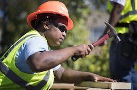 Jazmine Hawkins works on hammering studs into a wood foundation for a floor structure in Construction: Phase II class. ] (Leila Navidi/Star Tribune) l
