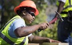 Jazmine Hawkins works on hammering studs into a wood foundation for a floor structure in Construction: Phase II class. ] (Leila Navidi/Star Tribune) l