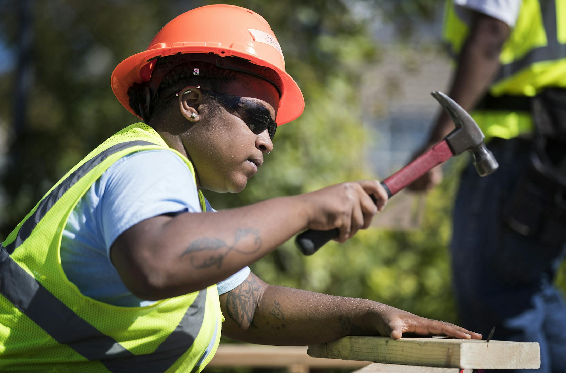 Jazmine Hawkins works on hammering studs into a wood foundation for a floor structure in Construction: Phase II class. ] (Leila Navidi/Star Tribune) leila.navidi@startribune.com BACKGROUND INFORMATION: Students work on building a wood foundation for a floor structure in Construction: Phase II class at Summit Academy OIC in Minneapolis on Wednesday, September 14, 2016. ORG XMIT: MIN1609141524020169