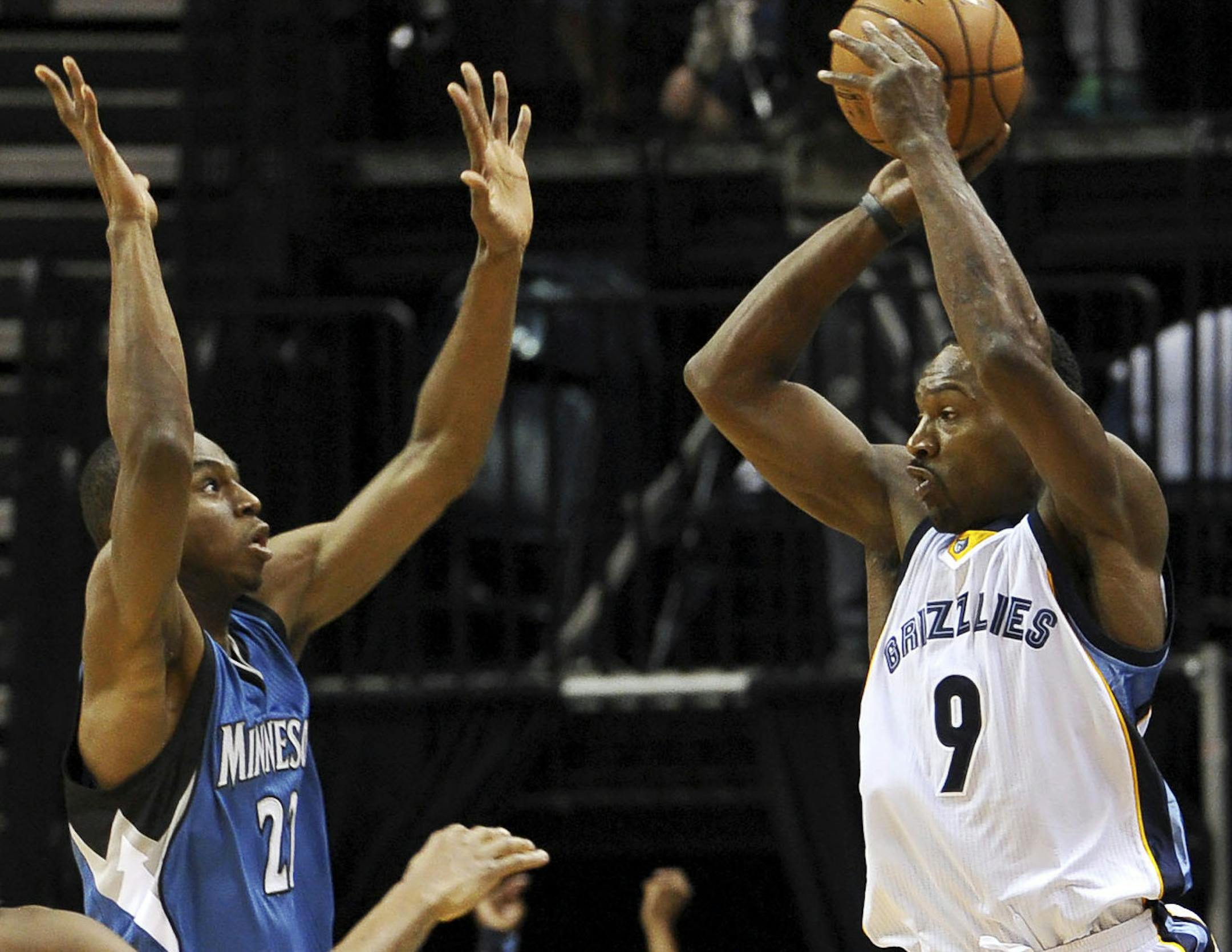 Memphis Grizzlies guard Tony Allen (9) leaps to pass over Minnesota Timberwolves guard Andrew Wiggins in the first half of an NBA basketball game Wednesday, Oct. 29, 2014, in Memphis, Tenn. (AP Photo/Brandon Dill)