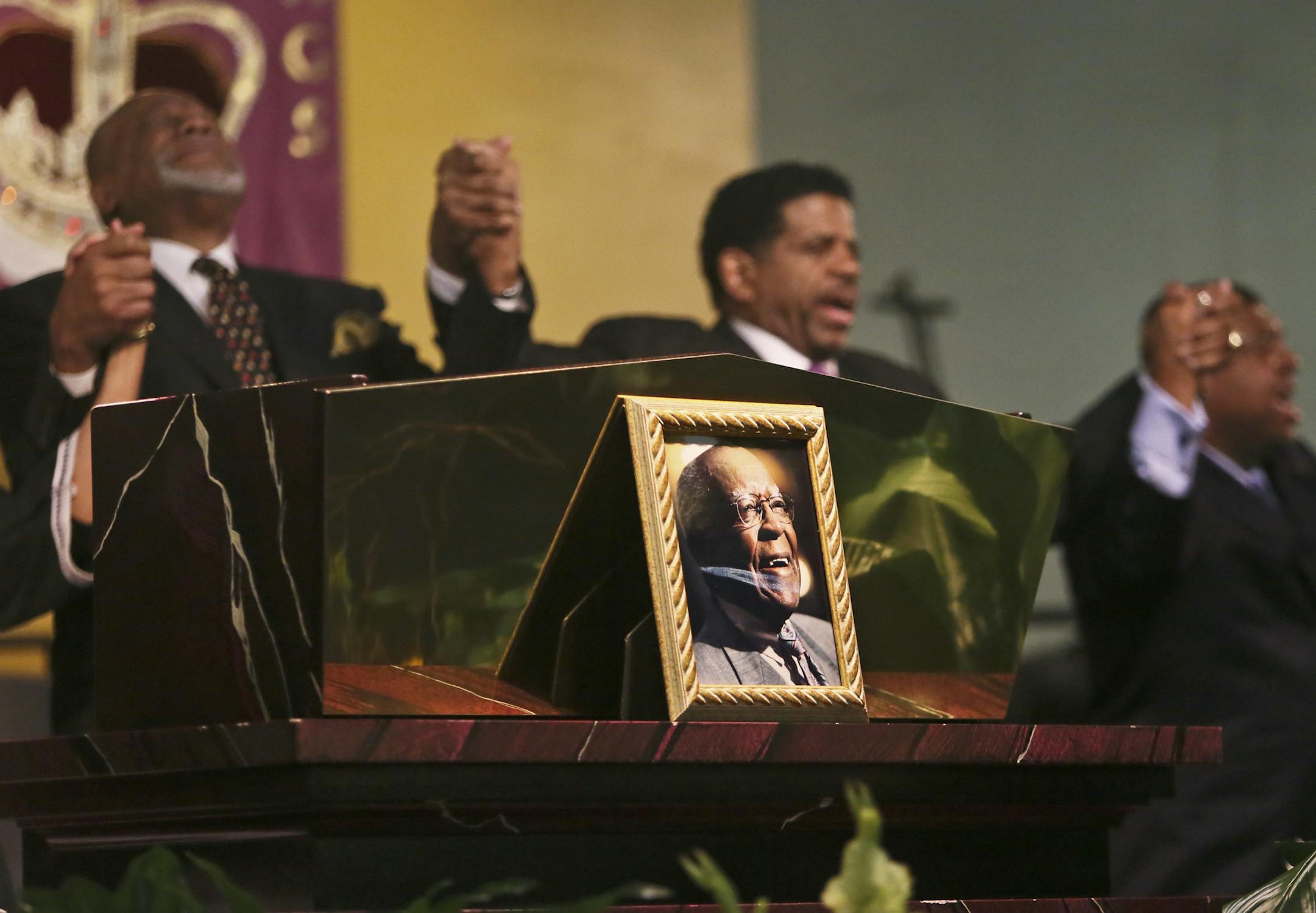 As "We Shall Overcome" was sung at the conclusion of the funeral service for civil rights giant Matthew Little, seen in the photograph, clergy members held hands Saturday at Shiloh Temple, including Shiloh Bishop Richard D. Howell, Jr., center.