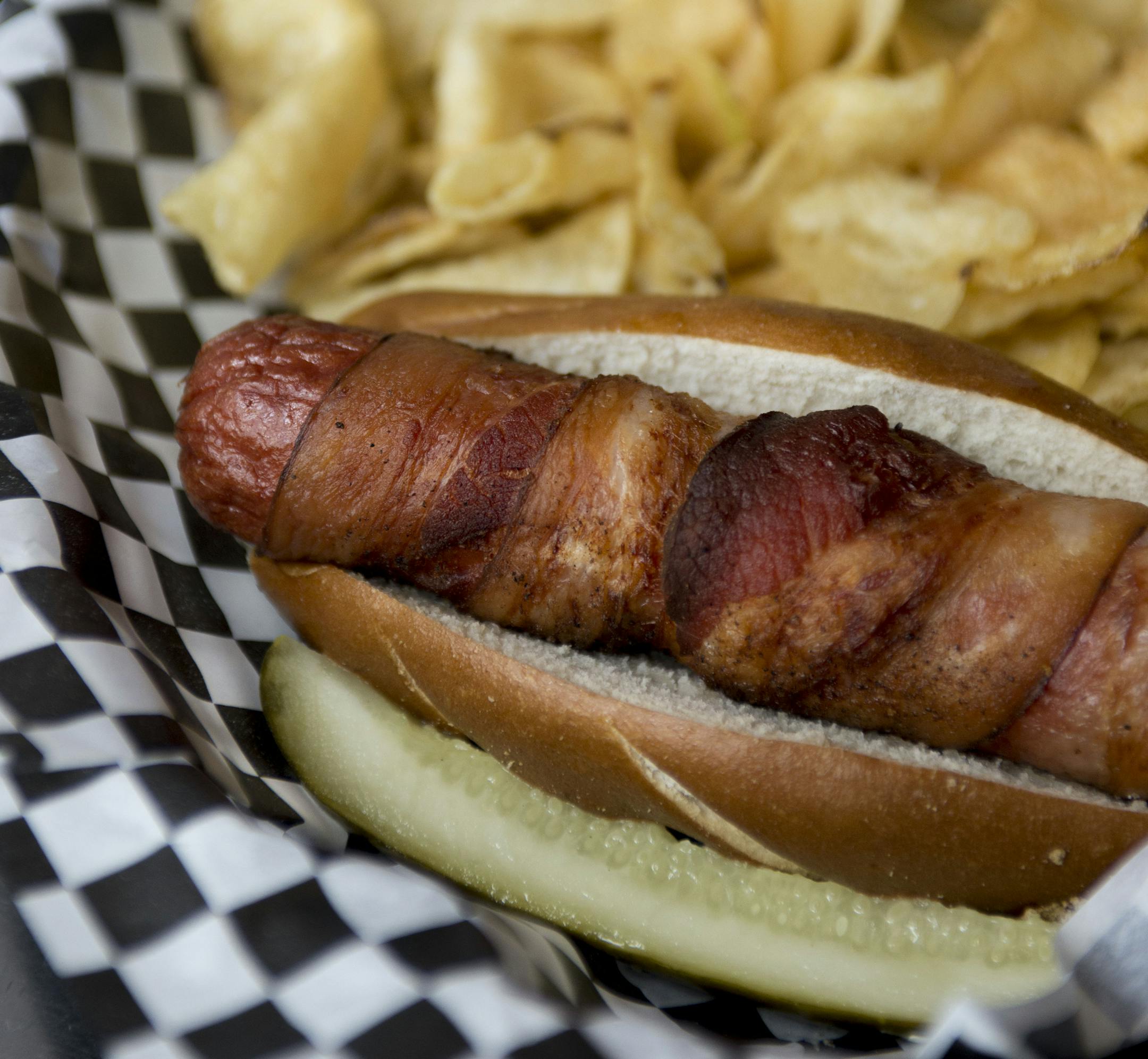 The Depot Tavern's Diamond Dog.] BRIDGET BENNETT SPECIAL TO THE STAR TRIBUNE &#x2022; bridget.bennett@startibune.com Wrapped in bacon and served with chips.