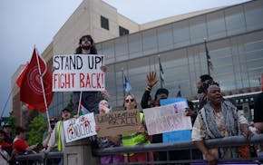 Demonstrators take part in an anti-Trump protest Friday outside the St. Paul RiverCentre in St. Paul.