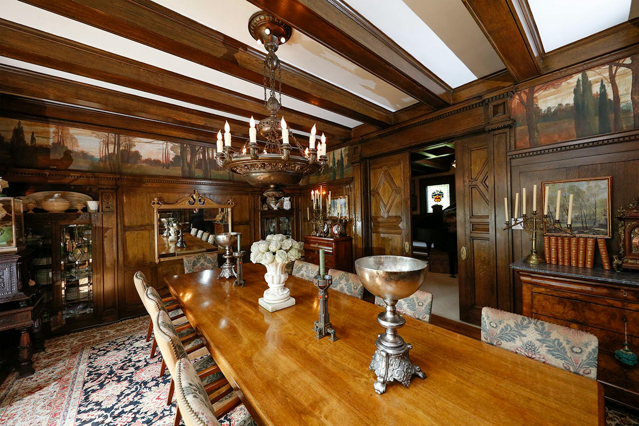 The dining room features a built-in buffet and original handpainted murals.