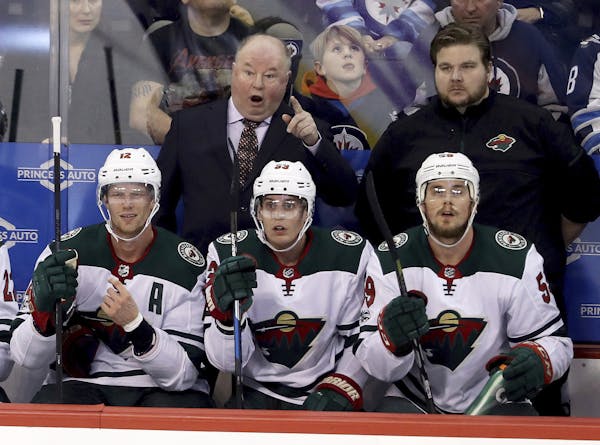 Minnesota Wild's head coach Bruce Boudreau reacts to a referee's call after a disallowed goal during the first period against Winnipeg.