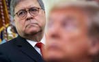 President Donald Trump with Attorney General William Barr over his shoulder, makes remarks while signing an executive order, establishing the Task For