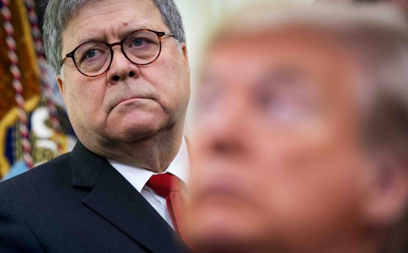 President Donald Trump with Attorney General William Barr over his shoulder, makes remarks while signing an executive order, establishing the Task Force on Missing and Murdered American Indians and Alaska Natives, at the White House in Washington on Tuesday, Nov. 26, 2019.