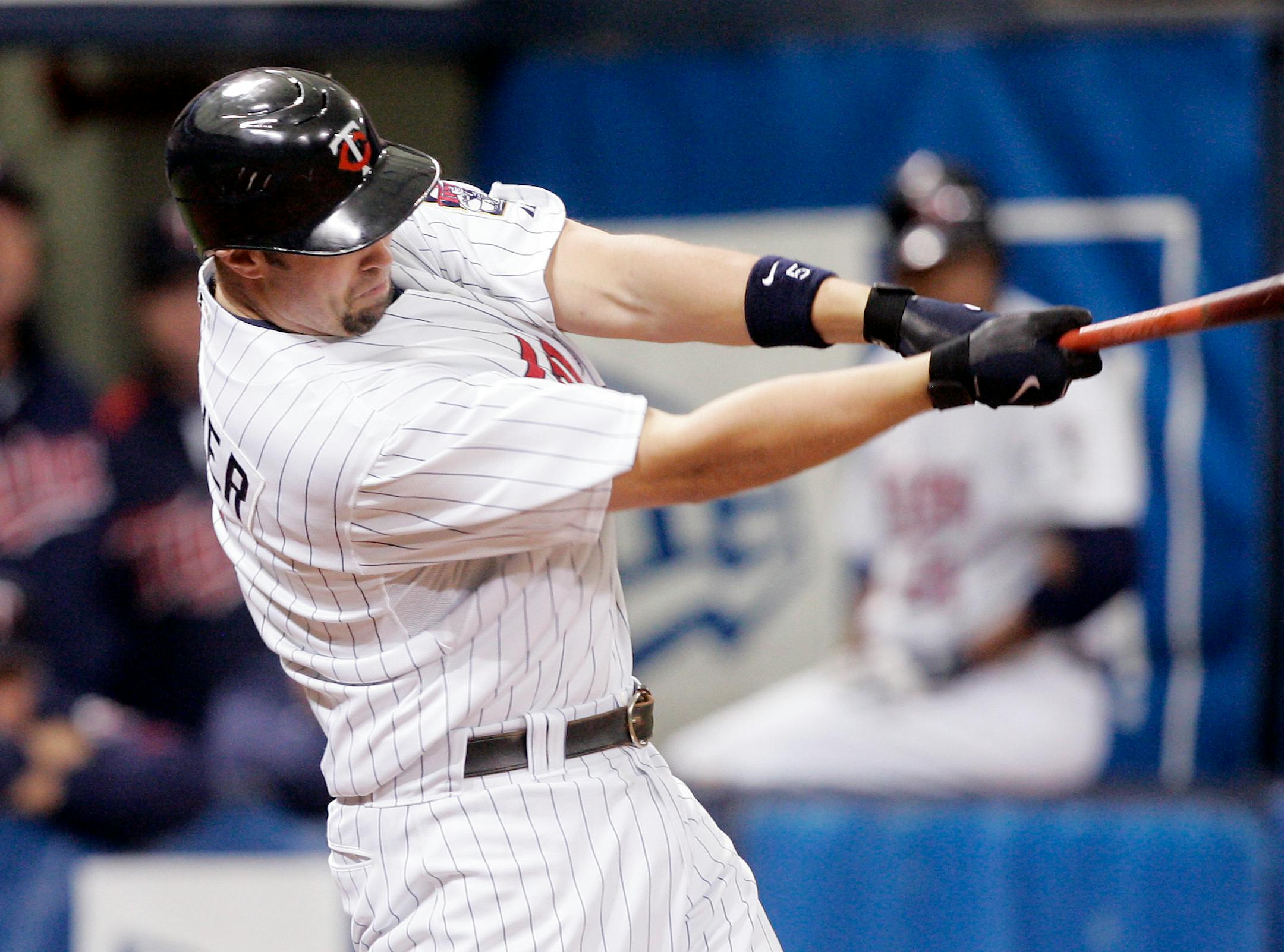 Minnesota Twins' Michael Cuddyer hits a single against the New York Yankees in fourth inning of a baseball game Sunday, June 1, 2008 in Minneapolis. Cuddyer drove in three runs in the Twins 5-1 win.