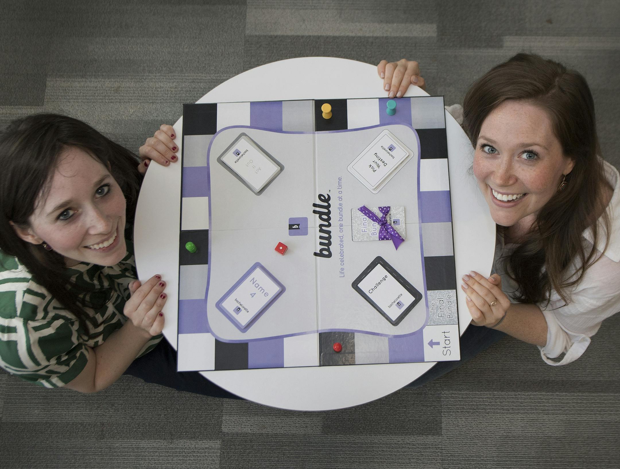 Cassie Collier and Jacklyn Collier pose for a photo with their customized board game " Bundle ", during an interview in Philadelphia, Pa. Thursday, June 21, 2018. The sisters are in their 30s -- one a former Peace Corps volunteer in Nicaragua with a master's from Harvard; the other an actress with a masters of fine arts in theater. They are currently roommates in New York City, but deep down are still coal region girls, born and raised in Mt. Carmel, Northumberland County. Their passion for home