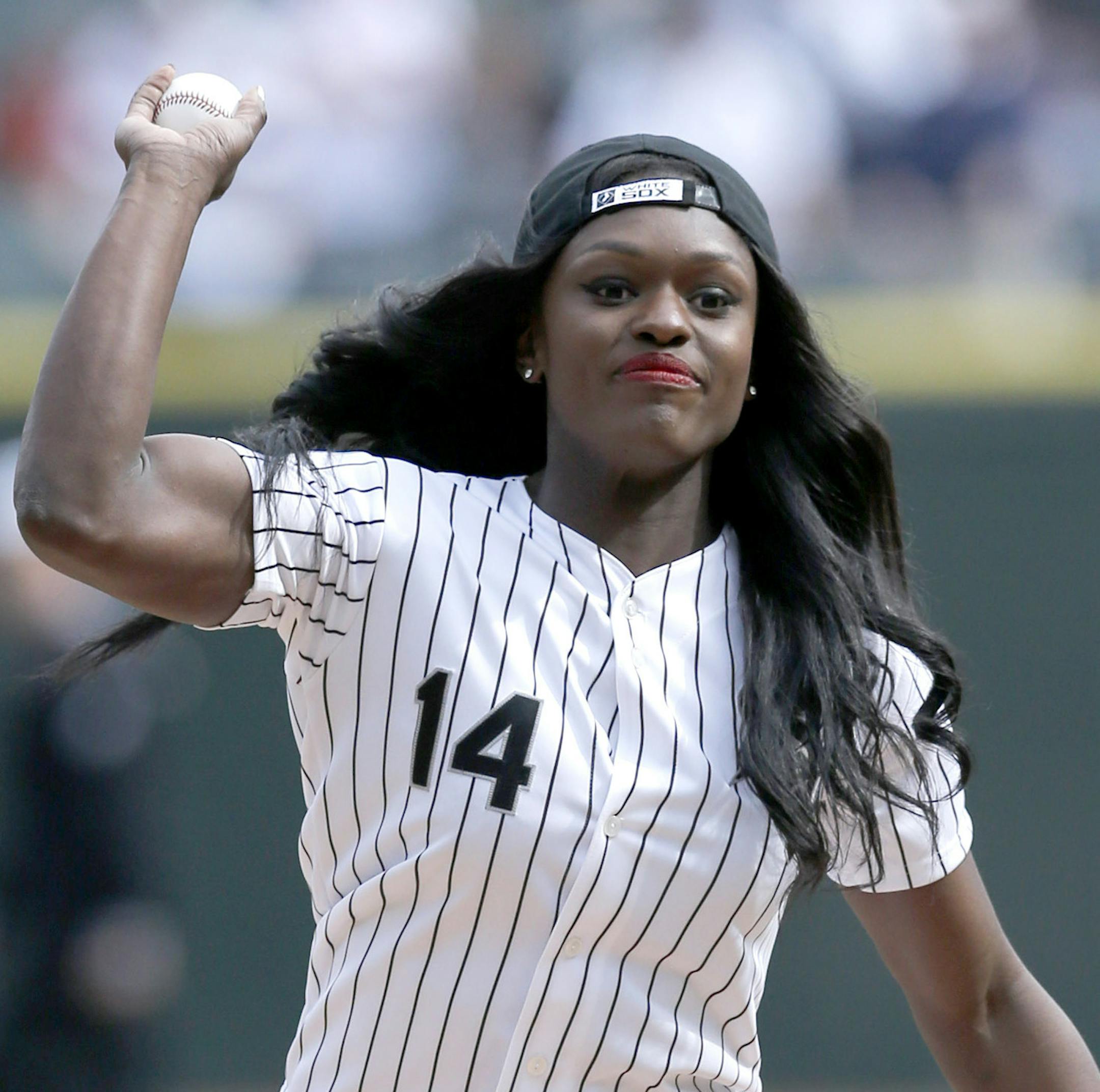 Olympian Aja Evans throws out a ceremonial first pitch before an opening day baseball game between the Chicago White Sox and the Minnesota Twins Monday, March 31, 2014, in Chicago. (AP Photo/Charles Rex Arbogast)