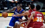 Los Angeles Clippers forward Kawhi Leonard, left, is defended by Denver Nuggets guards Jamal Murray, center, and PJ Dozier during the second half of a