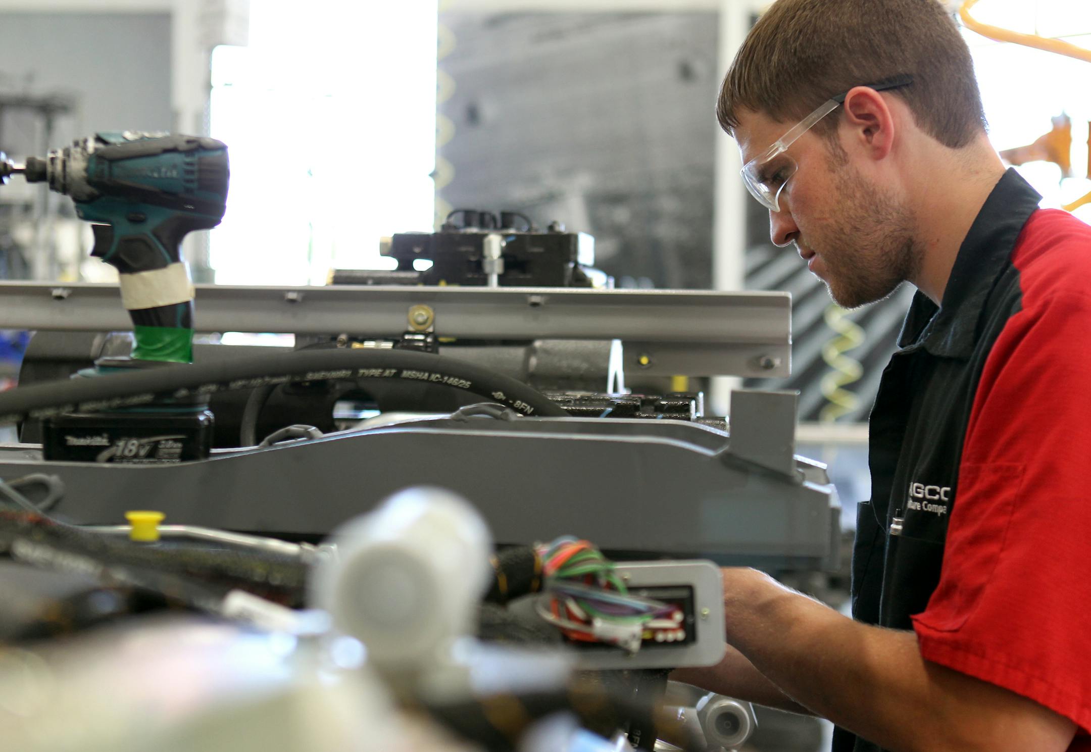 Wade Wiens installs a hydraulic line at the AGCO North American tractor production site in Jackson, Minn., on Thursday, July 18, 2013. AGCO has implemented an expansion project to add robotic welding equipment and more workers to grow production for increasing demand. ] (ANNA REED/STAR TRIBUNE) anna.reed@startribune.com (cq)