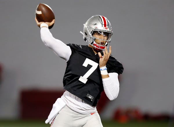 FILE - Ohio State quarterback C.J. Stroud passes during an NCAA college football practice in Columbus, Ohio, in this Monday, April 5, 2021, file photo