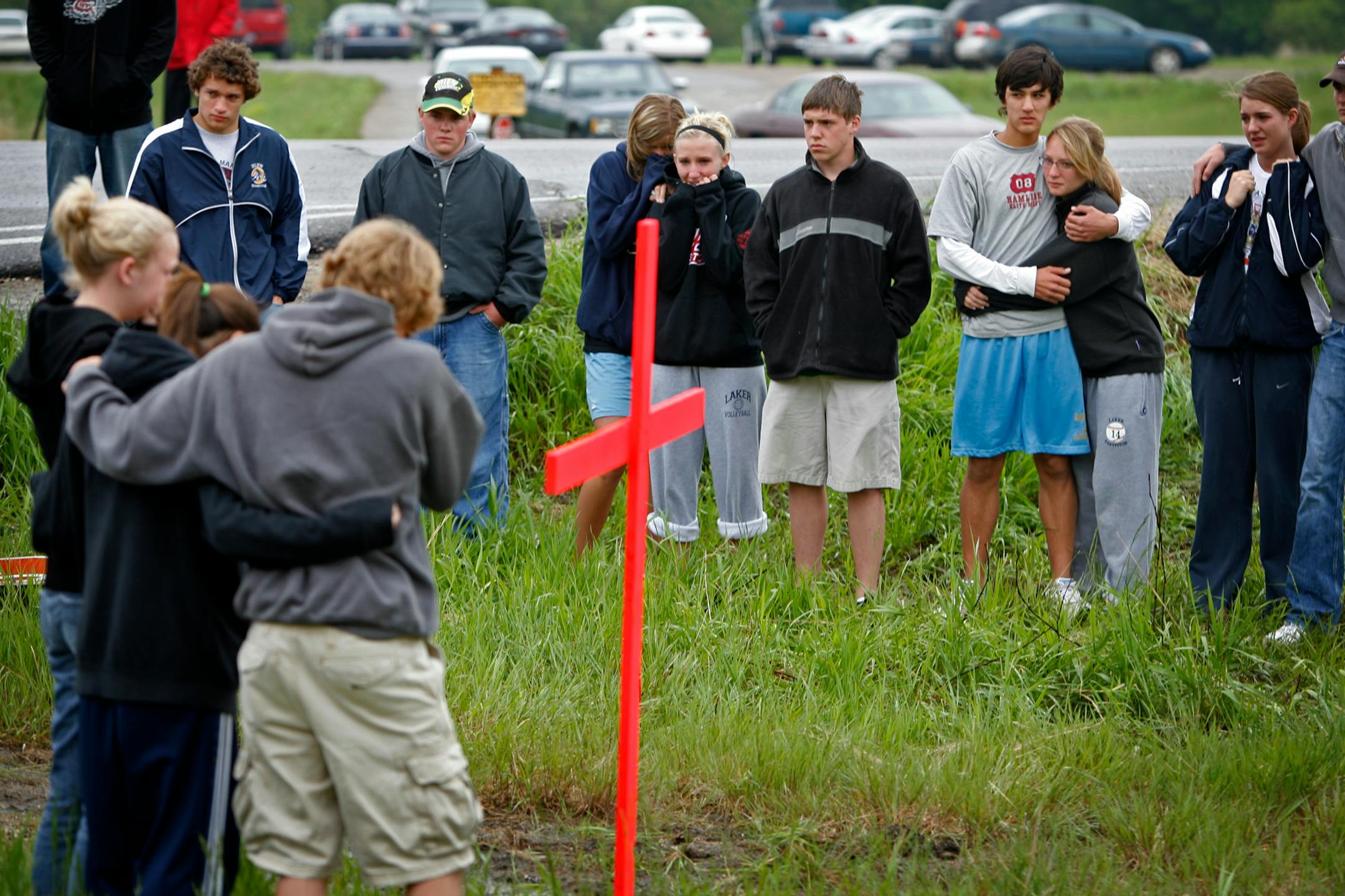 Friends and classmates of Madeysen Kleve gathered around the cross they had placed at the crash site. The teens were on their way home from a track meet in Collegeville, where they had gone to cheer on their classmates.