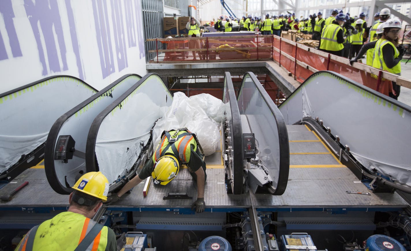 Workers work on an escalator at U.S. Bank Stadium in Minneapolis on Tuesday, February 16, 2016. ] (Leila Navidi/Star Tribune) leila.navidi@startribune.com