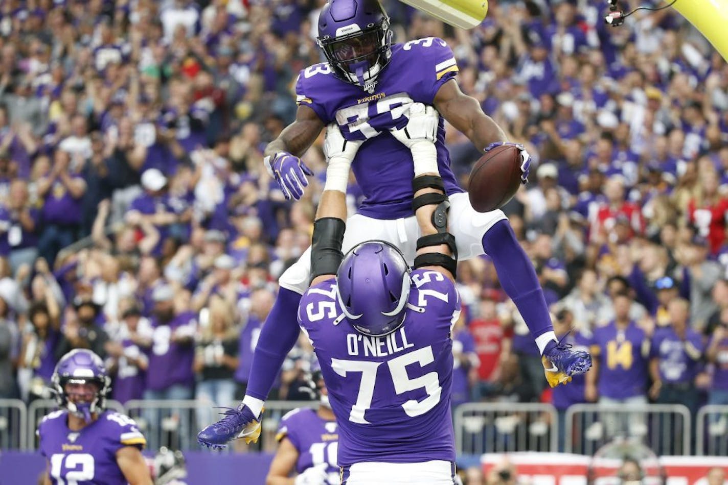 Minnesota Vikings running back Dalvin Cook (33) celebrates with teammate Brian O'Neill after a 19-yard touchdown run during the first half of an NFL football game against the Atlanta Falcons, Sunday, Sept. 8, 2019, in Minneapolis.