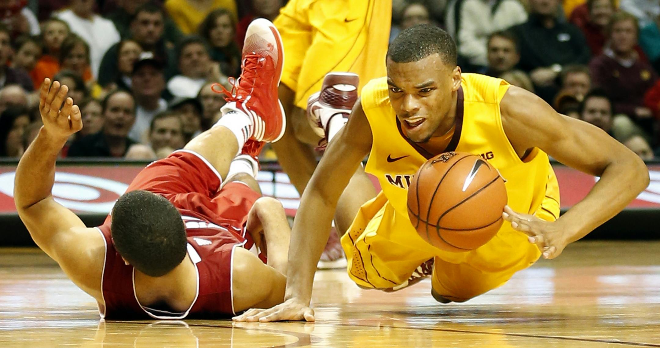 Gophers guard Andre Hollins fell to the ground after being fouled by Traevon Jackson in the second half.