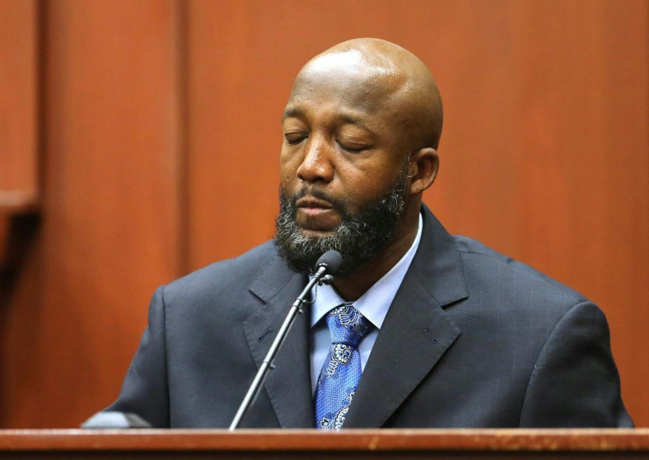 Tracy Martin, the father of Trayvon Martin, pauses as he testifies as a defense witness in the George Zimmerman trial in Seminole circuit court in Sanford, Florida, Monday, July 8, 2013. Zimmerman is charged with second-degree murder in the fatal shooting of Trayvon Martin, an unarmed teen, in 2012.
