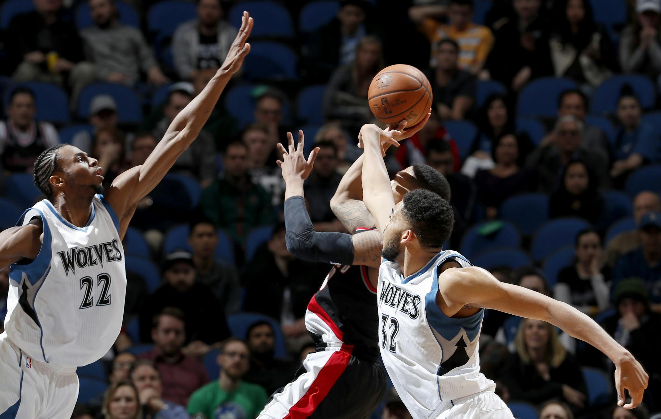 Andrew Wiggins (22) and Karl-Anthony Towns attempted to block a shot by Damian Lillard (0) in the fourth quarter.