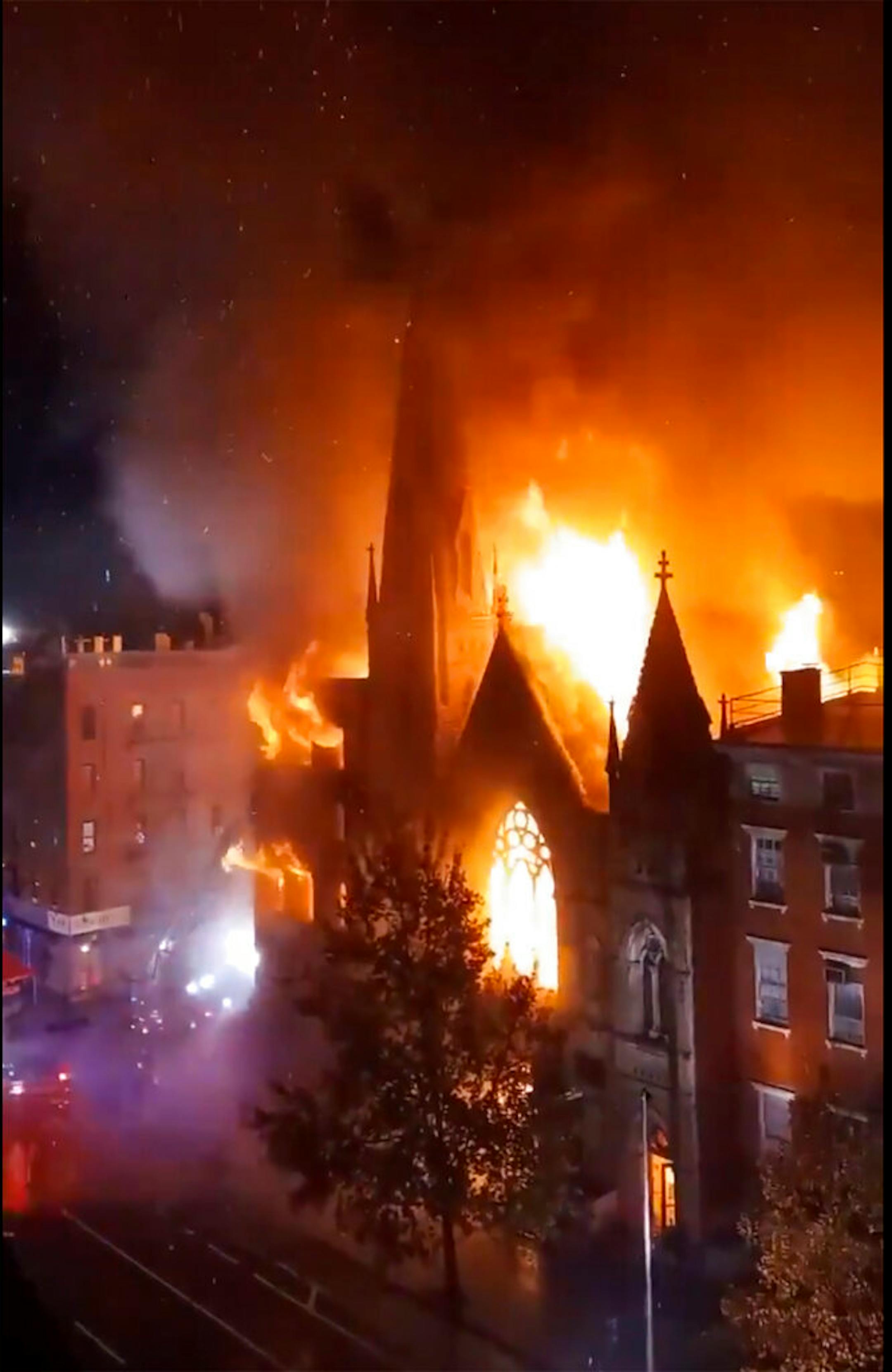 Firefighters work to extinguish a fire that erupted from a building next to Middle Collegiate Church on Saturday, Dec. 5, 2020 in New York.