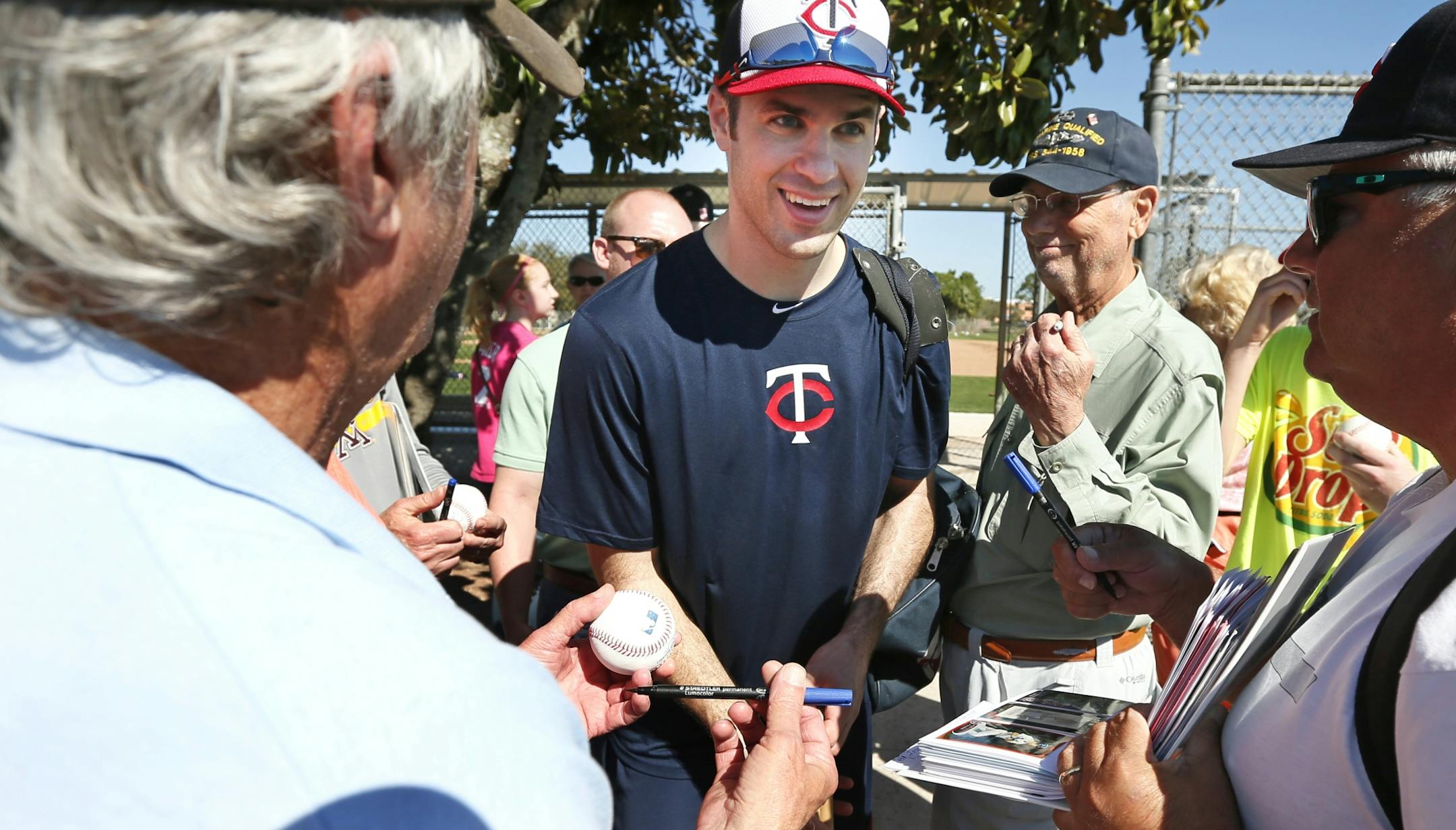 Twins first baseman Joe Mauer was surrounded by fans seeking autographs Tuesday Feb 17. 2014 in Fort Myers, Florida Lee County Sports Complex..