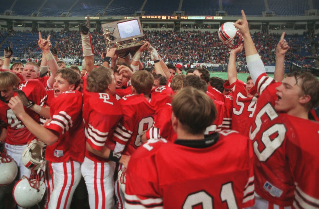 Detroit Lakes players celebrated after receiving the Class A trophy at the Dome.