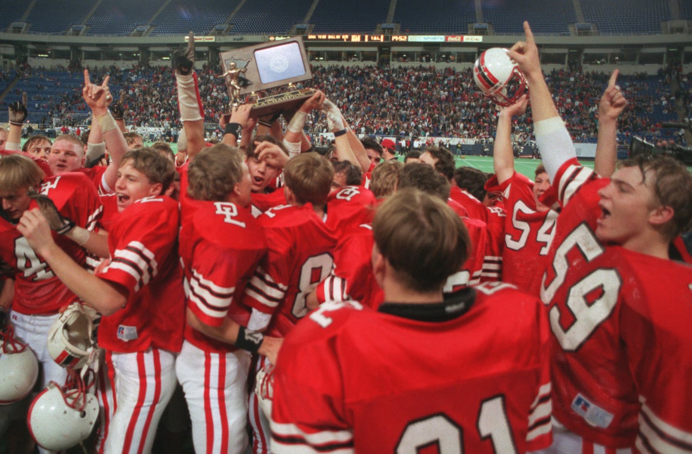 The Detroit Lakes team celebrates after receiving the Class A title trophy at the Dome...after defeating St.Peter.