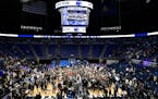 Penn State players and fans celebrate their 75-69 upset win over Michigan on Tuesday.