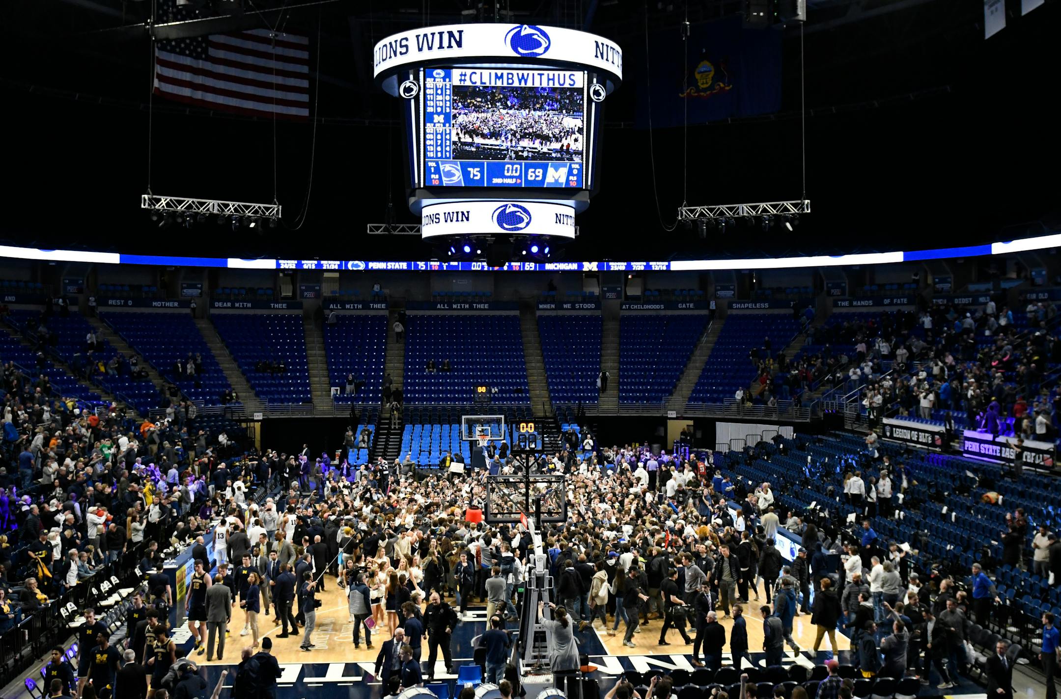 Penn State players and fans celebrate their 75-69 upset win over Michigan on Tuesday.