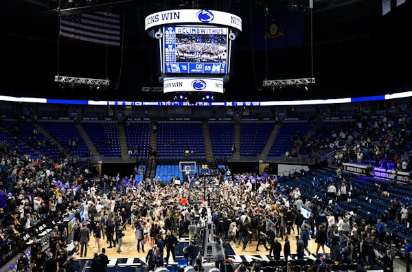 Penn State players and fans celebrate their 75-69 upset win over Michigan on Tuesday.