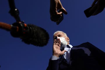 Democratic presidential candidate former Vice President Joe Biden speakers to reporters before he boards his plane at Duluth International Airport, in