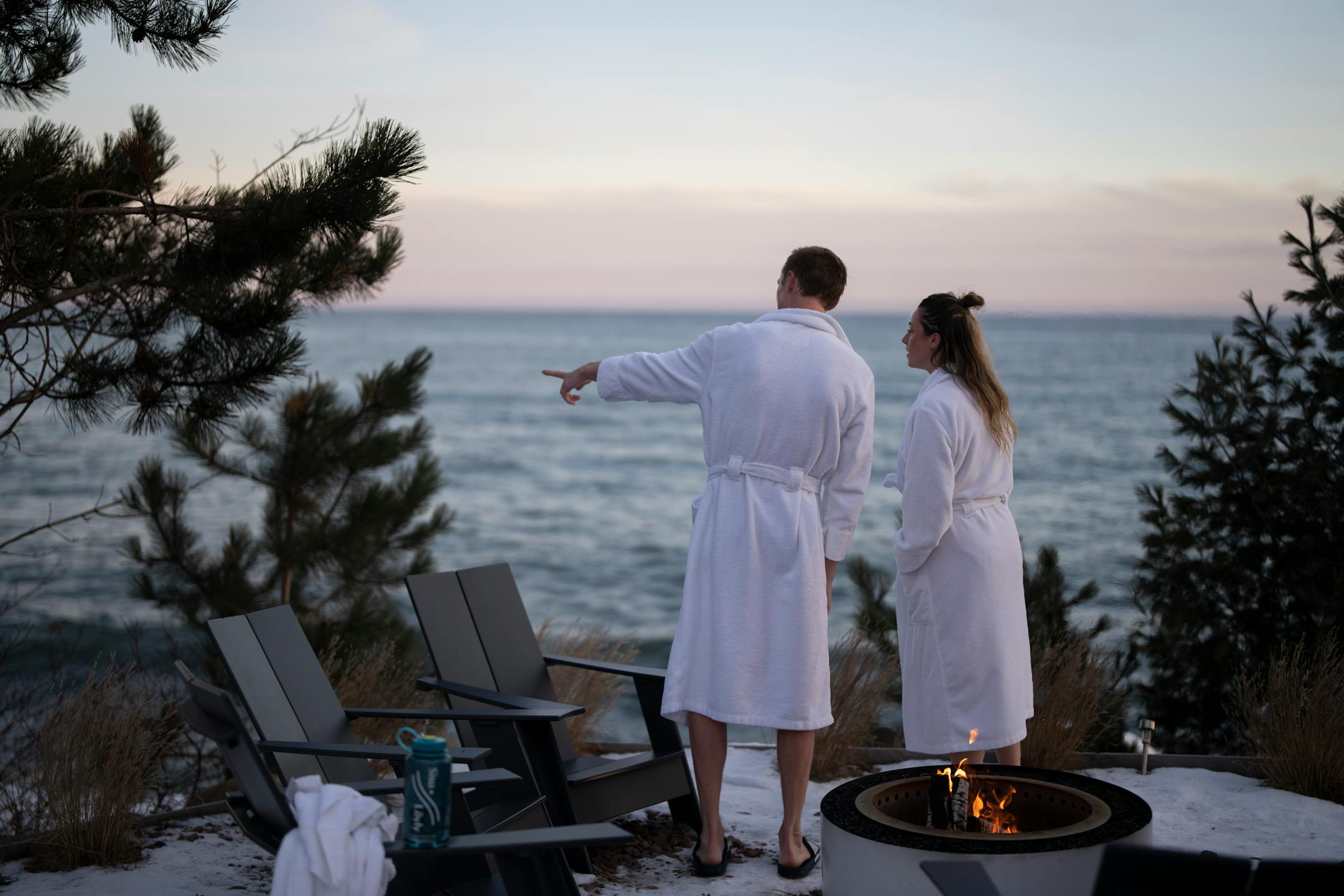 Shaun Tudor and Ana Macy watch the sun set after stepping out of a sauna to cool off at Sisu and Löyly Sauna.