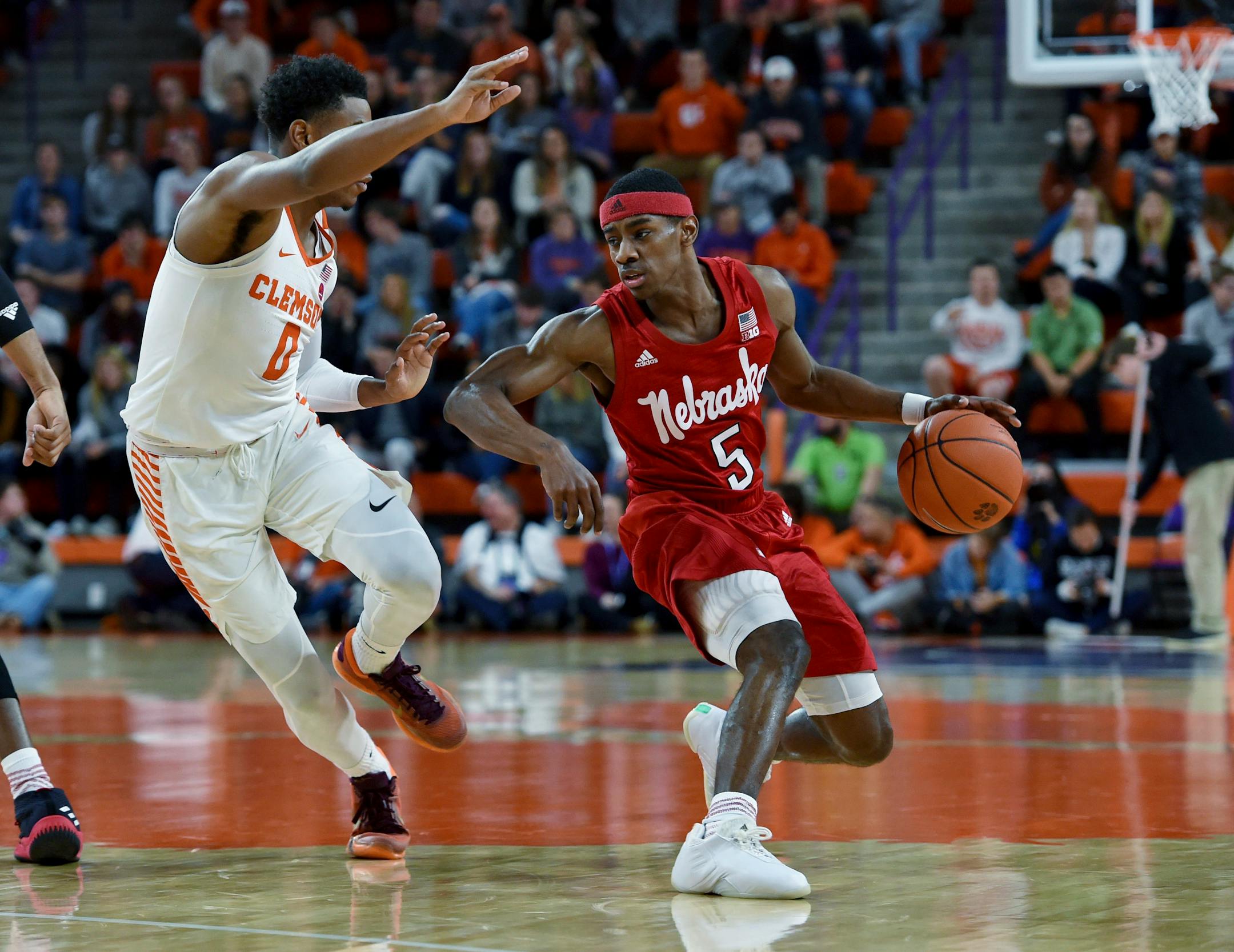 Nebraska's Glynn Watson Jr. brings the ball up the court while defended by Clemson's Clyde Trapp during the first half of an NCAA college basketball game Monday, Nov. 26, 2018, in Clemson, S.C. (AP Photo/Richard Shiro)