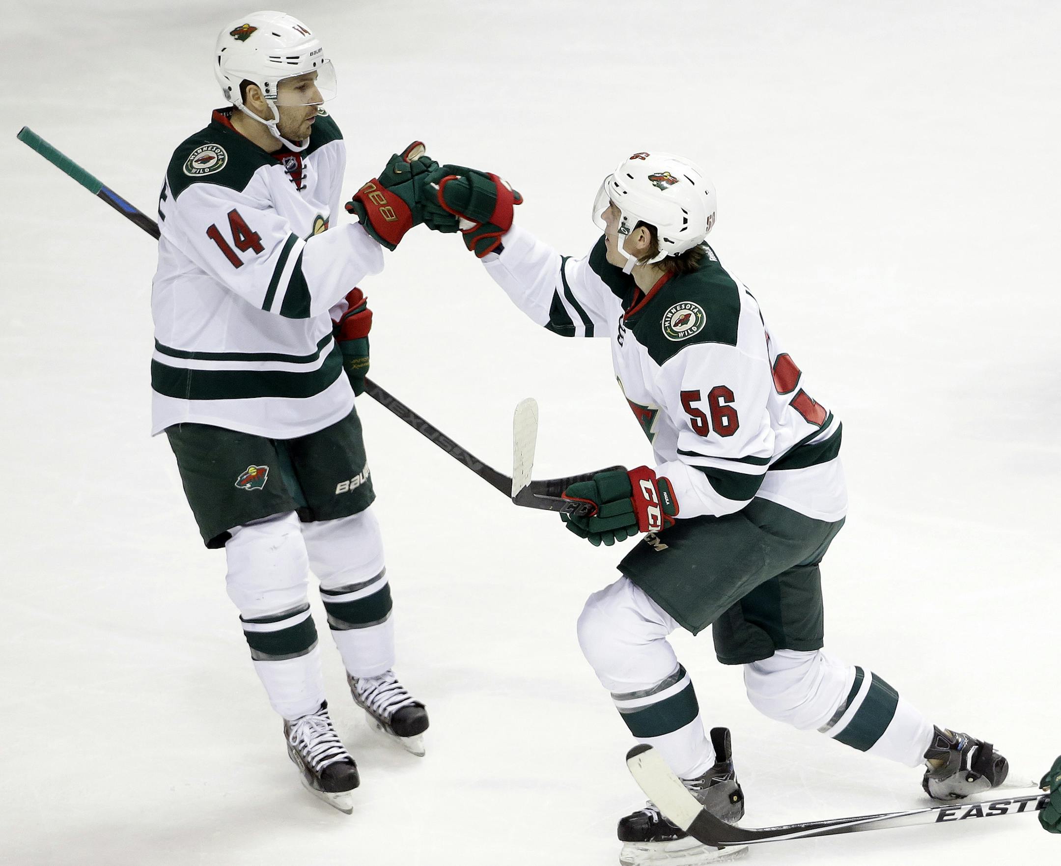 Minnesota Wild left wing Erik Haula (56), of Finland, celebrates with Justin Fontaine (14) after Haula scored a goal against the Nashville Predators in the first period of an NHL hockey game Thursday, Feb. 26, 2015, in Nashville, Tenn. (AP Photo/Mark Humphrey)