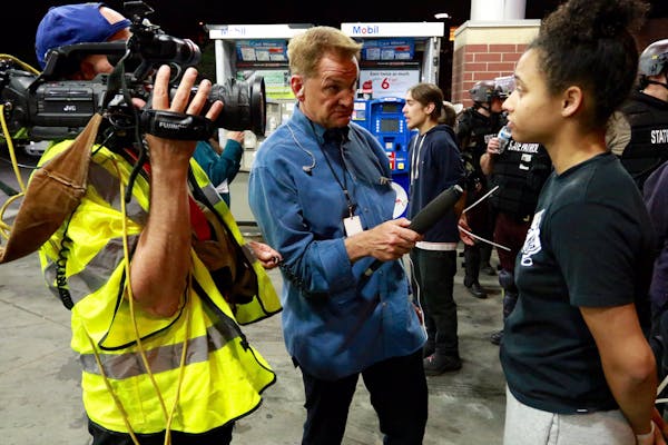 Mike Max interviews protesters at Bobby and Steve’s Auto World in Minneapolis on Sunday, May 31. Protesters were surrounded by MPD and arrested in a