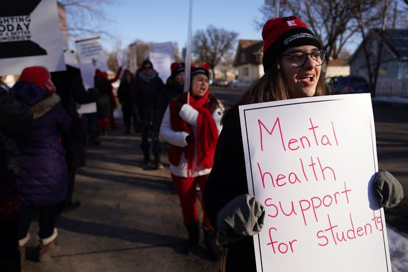 Music teacher Mackenzie Henson held a sign as she and fellow members of the St. Paul Federation of Educators picketed before school at Adams Spanish Immersion in St. Paul calling for a new contract with the creation of mental health teams in every building.