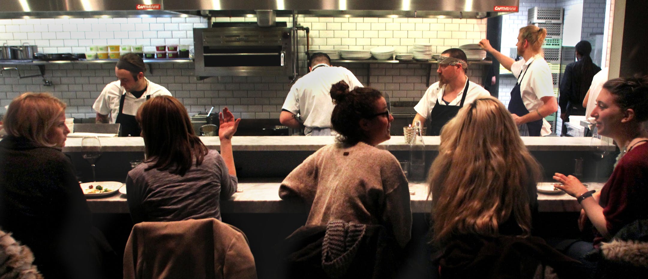 ABOVE: Customers sat next to the busy kitchen at Borough. Open kitchens are a popular feature at many restaurants that have made the Twin Cities what a recent transplant called &#x201c;a foodie community unlike anything I&#x2019;ve ever seen.&#x201d;