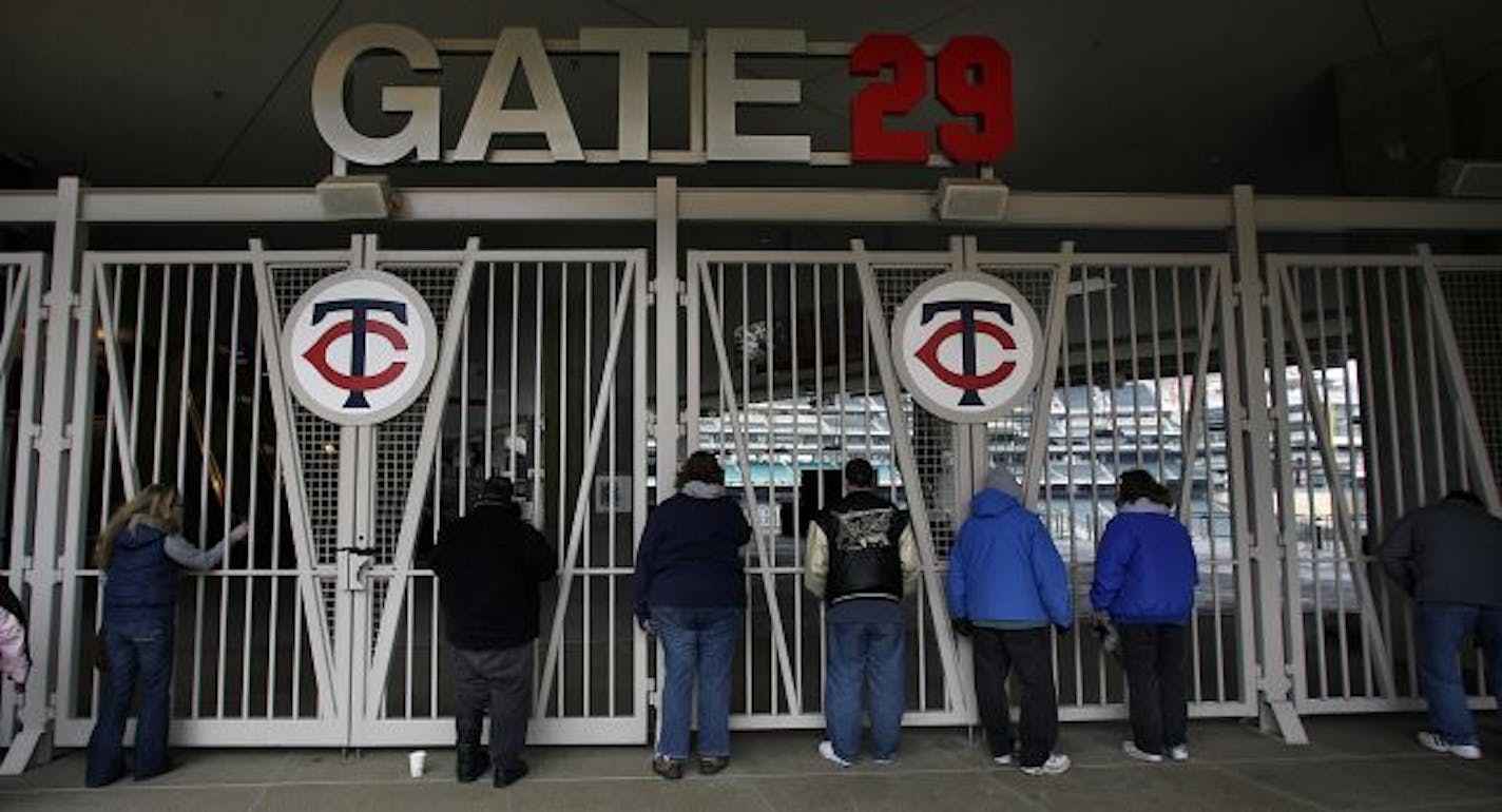 Fans stood outside one of the gates to Target Field, eager to get a look inside the new ballpark.