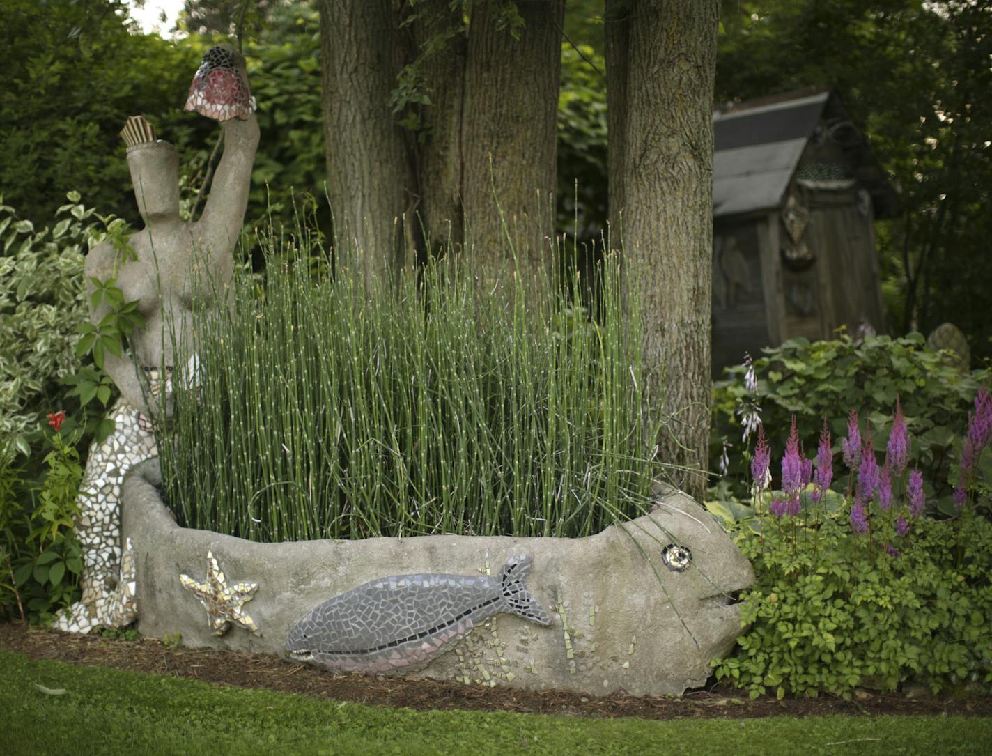 Sculptures rest in a flower bed in Wouterina de Raad's garden last summer. ] JEFF WHEELER &#xef; jeff.wheeler@startribune.com Artist Wouterina de Raad's garden is a showcase for her concrete mosaic sculptures on her farm in Beldenville, WI. Her gardens were photographed Tuesday, July 29, 2014.