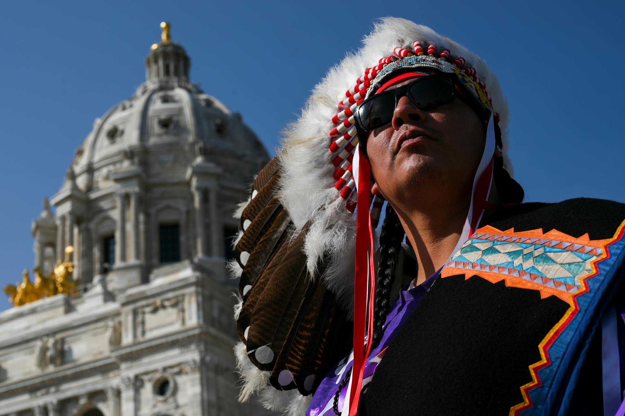 Walks through Hail, head warrior for the Red Lake Treaty Camp, looked out over the thousand-or-so demonstrators outside the Minnesota State Capitol Wednesday afternoon. He says he's been protesting at the camp for the past nine months and that he and his wife have been brutalized law enforcement.
