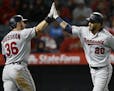 Minnesota Twins' Eddie Rosario, right, gets congratulations from Robbie Grossman after Rosario hits a solo home run against the Los Angeles Angels dur