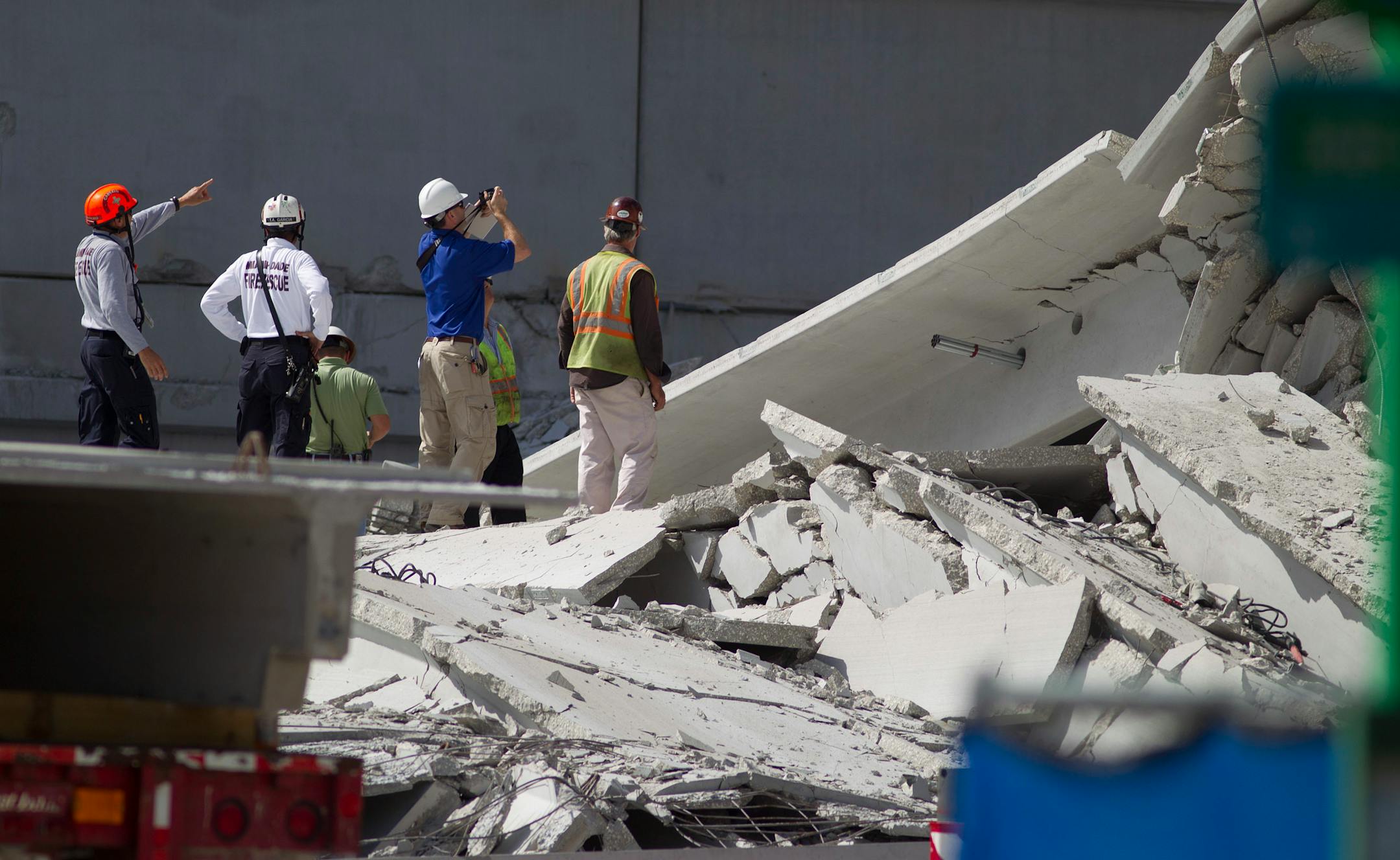 Rescue officials survey damage in the collapsed parking garage at the Miami Dade College West campus in Doral, Fla. Thursday, Oct. 11, 2012. One person is still missing. (AP Photo/J Pat Carter)