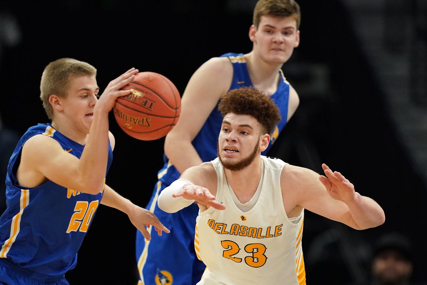 DeLaSalle forward Jamison Battle (23) tried to swat the ball away from Waseca guard Zach Hoehn (20) in the first half. ] ANTHONY SOUFFLE • anthony.souffle@startribune.com